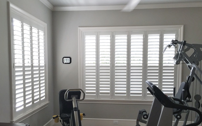Chicago home gym with shuttered windows.